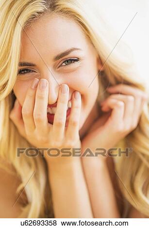 Stock Photo - Portrait of teenage girl (16-17) smiling. Fotosearch