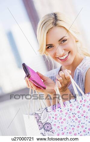 Portrait of teenage girl (16-17) holding shopping bags View Large Photo Image Stock Image - Portrait of teenage girl (16-17) holding shopping bags. Fotosearch