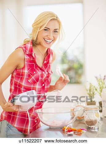 Portrait of teenage girl (16-17) preparing food View Large Photo Image Stock Photo - Portrait of teenage girl (16-17) preparing food. Fotosearch