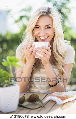 Stock Photo - Portrait of teenage girl (16-17) drinking coffee . Fotosearch