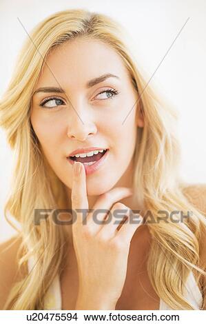 Portrait of teenage girl (16-17) with finger on lips View Large Photo Image Picture - Portrait of teenage girl (16-17) with finger on lips. Fotosearch