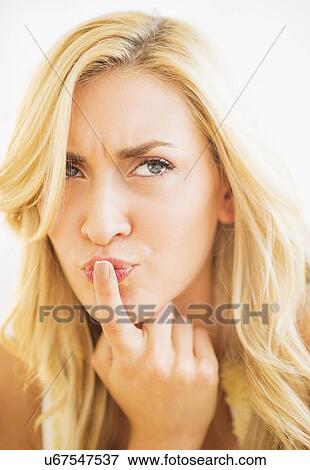 Portrait of teenage girl (16-17) with finger on lips View Large Photo Image Stock Photo - Portrait of teenage girl (16-17) with finger on lips. Fotosearch