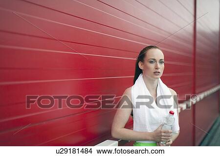 Picture - Portrait of woman holding bottle of water. Fotosearch