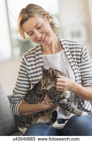 Portrait of woman holding cat View Large Photo Image Stock Image - Portrait of woman holding cat. Fotosearch