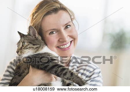 Portrait of woman holding cat View Large Photo Image Stock Photo - Portrait of woman holding cat. Fotosearch