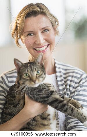Portrait of woman holding cat View Large Photo Image Stock Photograph - Portrait of woman holding cat. Fotosearch