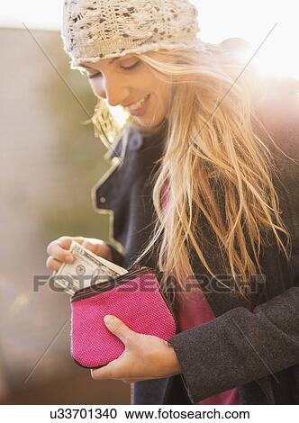 Portrait of woman holding purse with banknotes View Large Photo Image Stock Image - Portrait of woman holding purse with banknotes. Fotosearch