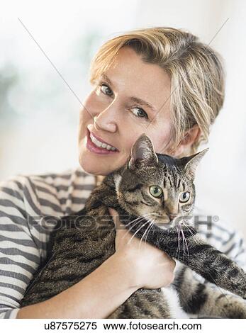 Portrait of woman hugging cat View Large Photo Image Stock Photography - Portrait of woman hugging cat. Fotosearch