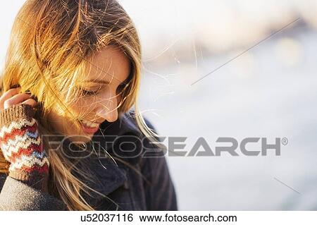 Stock Photograph - Portrait of woman in sunlight. Fotosearch