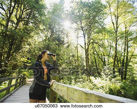 Portrait of woman looking at view with binoculars View Large Photo Image Stock Image - Portrait of woman looking at view with binoculars. Fotosearch