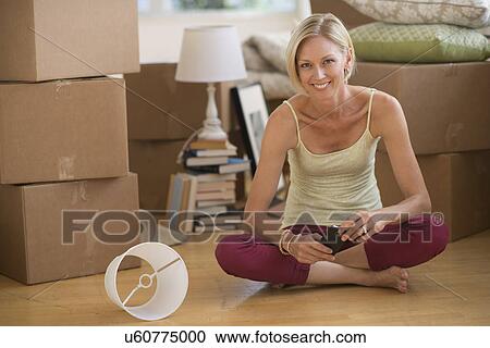 Portrait of woman sitting on floor of new home View Large Photo Image Stock Image - Portrait of woman sitting on floor of new home. Fotosearch