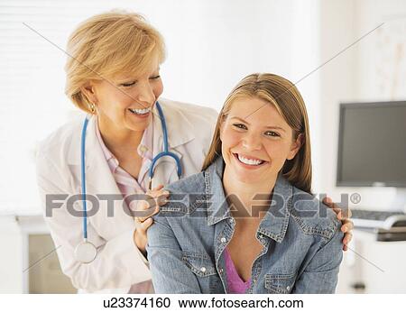 Portrait of young woman and her doctor View Large Photo Image Stock Image - Portrait of young woman and her doctor. Fotosearch