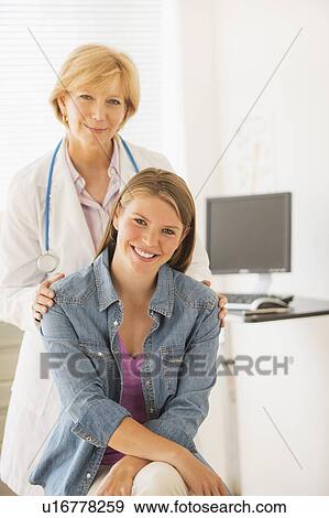 Portrait of young woman and her doctor View Large Photo Image Stock Photo - Portrait of young woman and her doctor. Fotosearch