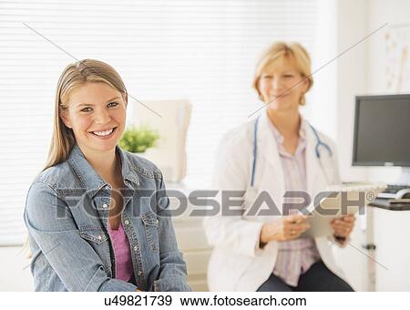 Stock Photo - Portrait of young woman visiting doctor. Fotosearch