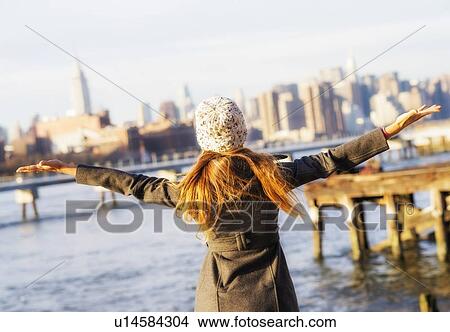 Rear view of blond woman with arms outstretched View Large Photo Image Picture - Rear view of blond woman with arms outstretched. Fotosearch