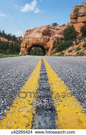 Road going under natural tunnel View Large Photo Image Picture - Road going under natural tunnel. Fotosearch