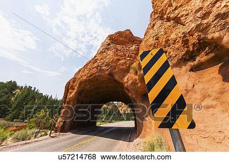 Road going under natural tunnel View Large Photo Image Stock Photo - Road going under natural tunnel. Fotosearch