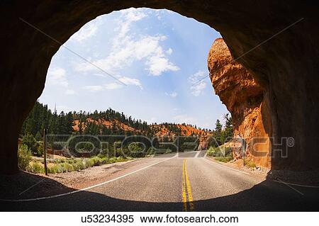 Road going under natural tunnel View Large Photo Image Stock Photography - Road going under natural tunnel. Fotosearch