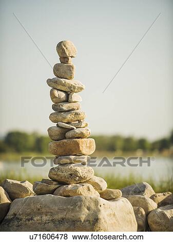 Stack of stones by lake View Large Photo Image Stock Photo - Stack of stones by lake. Fotosearch