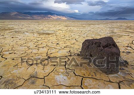 Stormy clouds over cracked earth View Large Photo Image Stock Image - Stormy clouds over cracked earth. Fotosearch