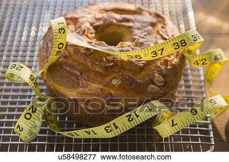 Studio Shot of bundt cake and tape measure View Large Photo Image Stock Photo - Studio Shot of bundt cake and tape measure. Fotosearch