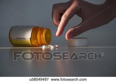 Stock Photo - Studio shot of hand reaching for pill. Fotosearch