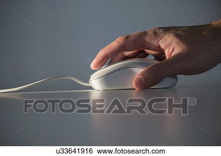 Studio shot of hand using computer mouse View Large Photo Image Stock Photograph - Studio shot of hand using computer mouse. Fotosearch