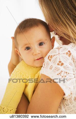 Studio Shot of mother holding daughter (2-5 months) View Large Photo Image Stock Image - Studio Shot of mother holding daughter (2-5 months). Fotosearch