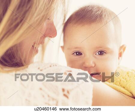 Studio Shot of mother holding daughter (2-5 months) View Large Photo Image Stock Photograph - Studio Shot of mother holding daughter (2-5 months). Fotosearch