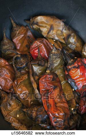 Stock Image - Studio shot of roasted chili peppers. Fotosearch