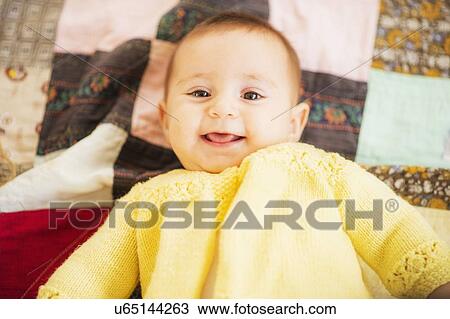 Stock Image - Studio Shot of smiling baby girl (2-5 months). Fotosearch