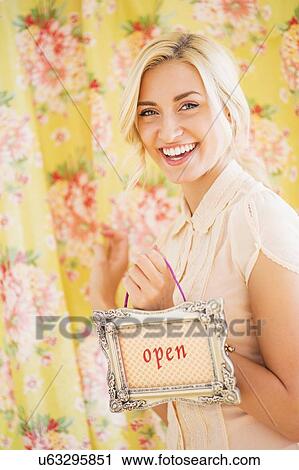 Teen (16-17) girl holding open sign View Large Photo Image Stock Image - Teen (16-17) girl holding open sign. Fotosearch