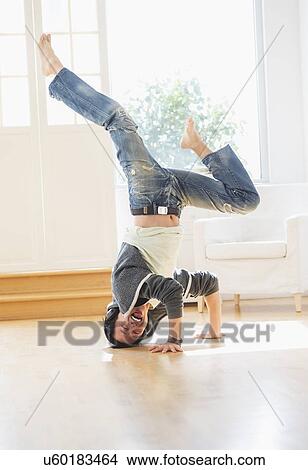 Teenage boy (16-17) dancing in living room View Large Photo Image Picture - Teenage boy (16-17) dancing in living room. Fotosearch