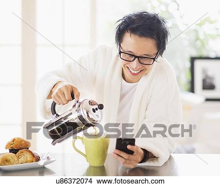 Teenage boy (16-17) eating breakfast View Large Photo Image Picture - Teenage boy (16-17) eating breakfast. Fotosearch