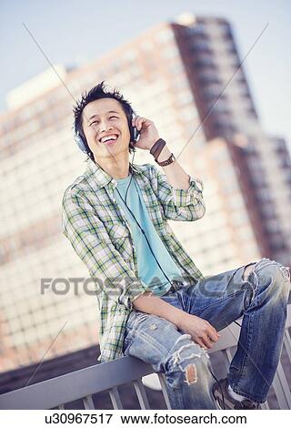 Teenage boy (16-17) listening to music View Large Photo Image Stock Photo - Teenage boy (16-17) listening to music. Fotosearch
