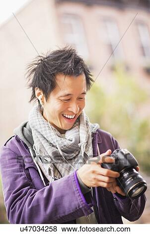 Teenage boy (16-17) with camera View Large Photo Image Stock Photo - Teenage boy (16-17) with camera. Fotosearch