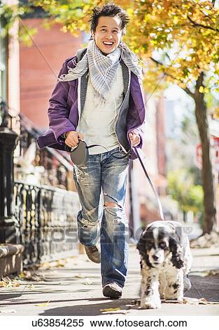 Teenage boy(16-17) walking with dog View Large Photo Image Stock Photography - Teenage boy(16-17) walking with dog. Fotosearch