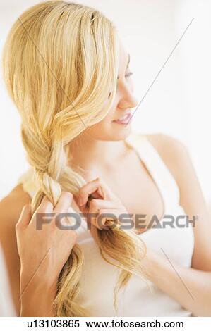 Teenage girl (16-17) braiding hair View Large Photo Image Stock Photography - Teenage girl (16-17) braiding hair. Fotosearch