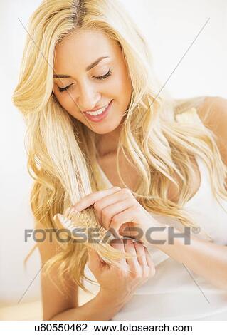 Stock Image - Teenage girl (16-17) brushing hair. Fotosearch