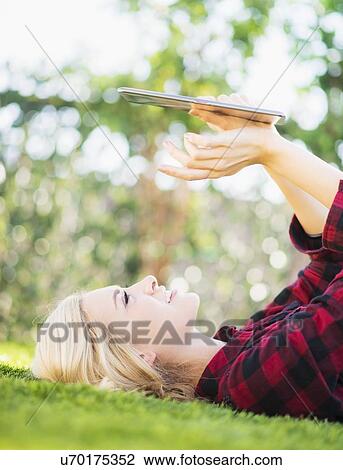 Stock Image - Teenage girl (16-17) using digital tablet. Fotosearch