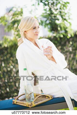 Teenage girl (16-17) wearing bathrobe sitting in garden View Large Photo Image Stock Image - Teenage girl (16-17) wearing bathrobe sitting in garden. Fotosearch