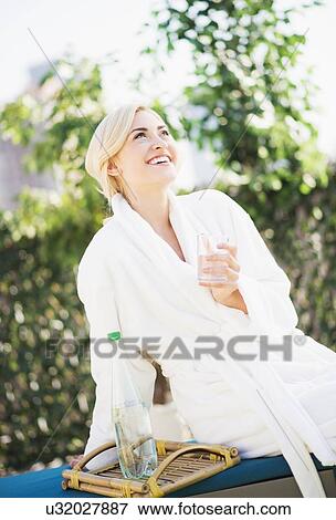 Teenage girl (16-17) wearing bathrobe sitting in garden View Large Photo Image Stock Photo - Teenage girl (16-17) wearing bathrobe sitting in garden. Fotosearch
