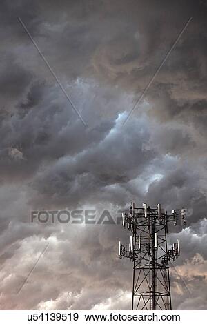 Stock Photo - Telecommunication antenna in front of storm clouds. Fotosearch