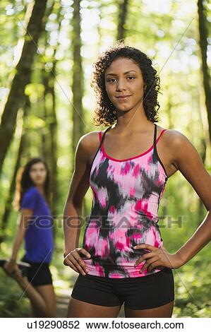 Stock Image - Two young women exercising. Fotosearch