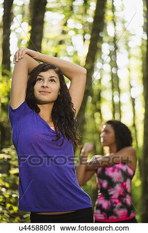 Stock Image - Two young women stretching. Fotosearch