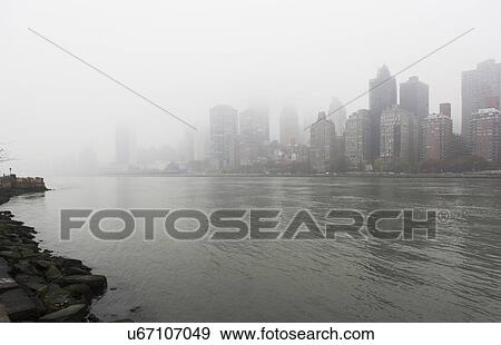 Stock Photo - View of city over river. Fotosearch