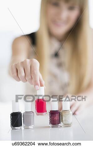 Woman choosing nail polish View Large Photo Image Picture - Woman choosing nail polish. Fotosearch