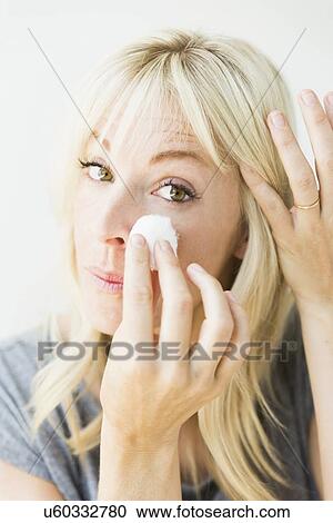 Stock Image - Woman cleaning face. Fotosearch