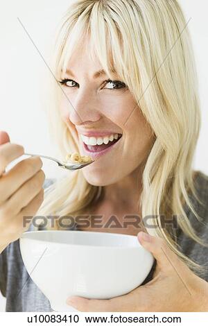 Woman eating cereals View Large Photo Image Stock Image - Woman eating cereals. Fotosearch