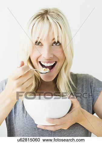 Stock Image - Woman eating cereals. Fotosearch